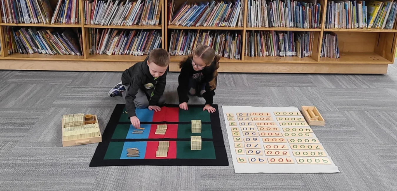 Two children working with Montessori Materials